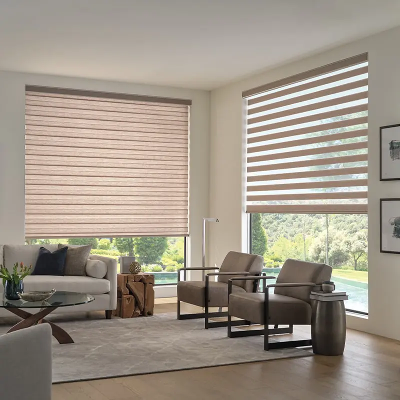 Elegant living room featuring beige and striped window shades, minimalist furniture, and large windows overlooking nature, perfect for interiors showcasing window treatments, home design, and natural lighting.