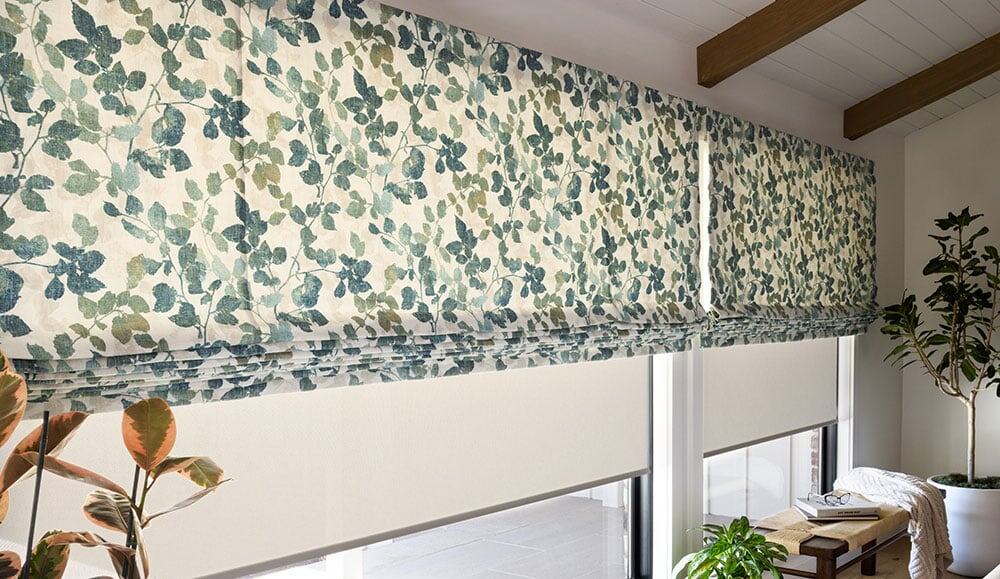 Linen floral patterned window shades with greenery decor in a modern living space.