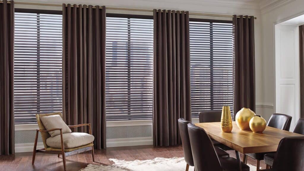 Bright dining area featuring wooden blinds, contemporary furniture, and stylish decor accessories.