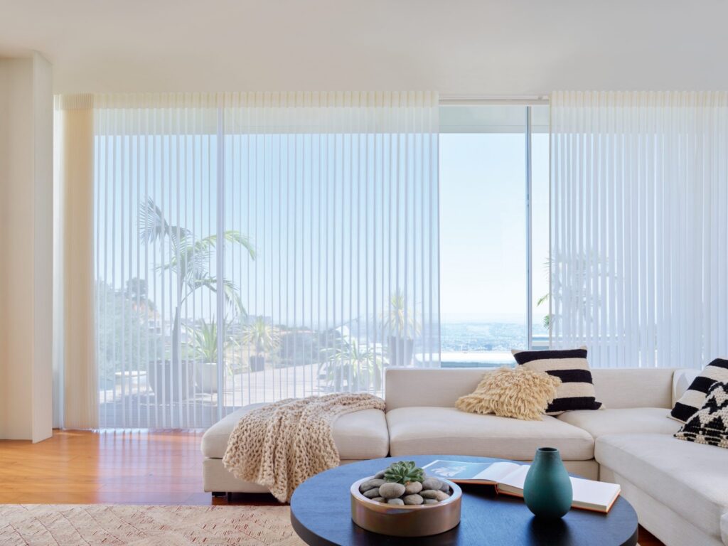 Luminette® Privacy Sheers in Stria™ with PowerView® Automation in a living room